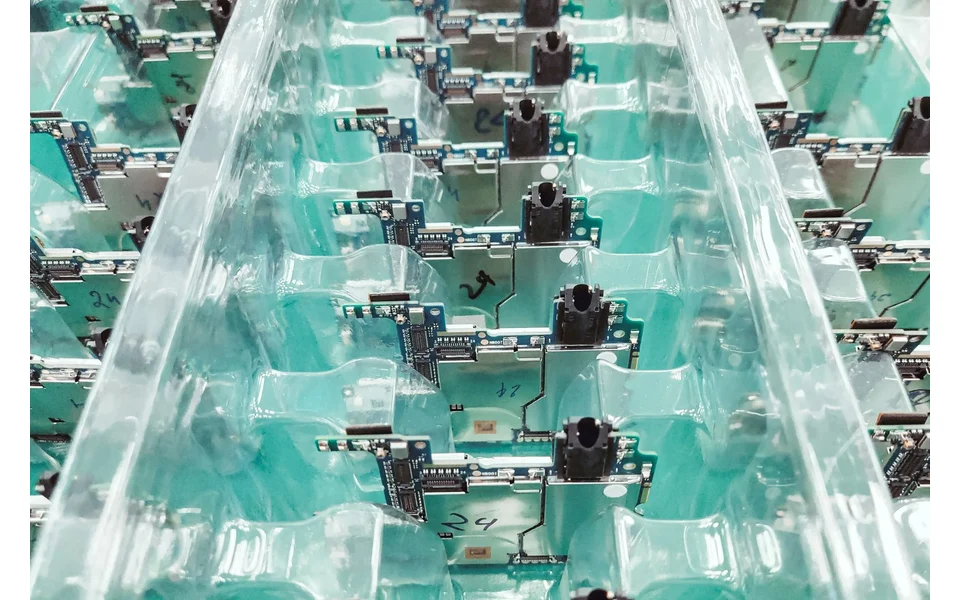 Circuit boards arranged in a rack during electronics manufacturing.